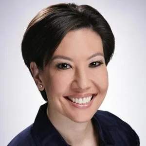 Portrait of a Smiling Female Dental Professional Smiling female dental professional with short dark hair wearing a navy blue top.