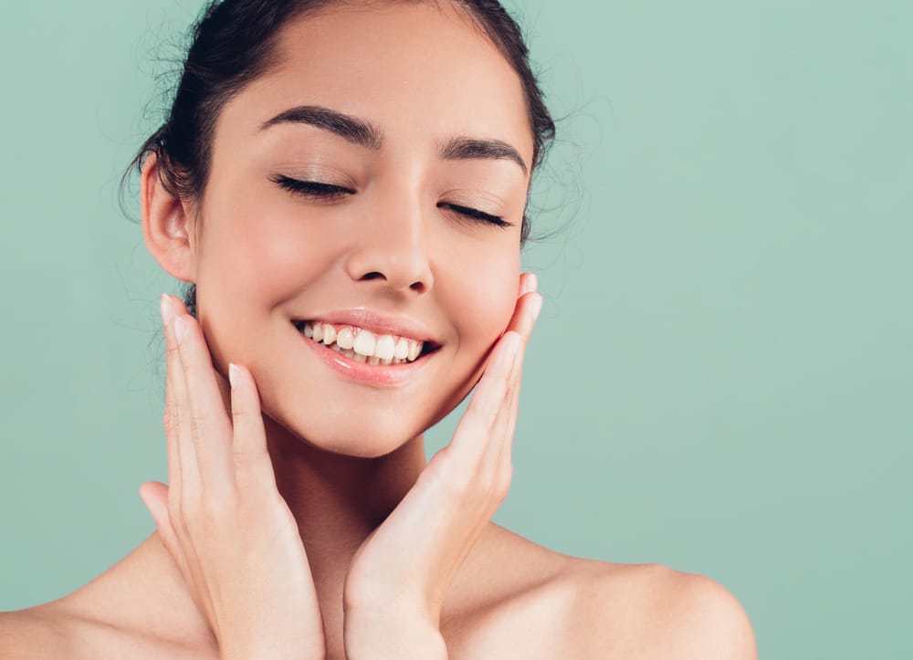 Relaxed woman with glowing skin and smooth complexion – Botox Kirkland Woman smiling softly with smooth, youthful skin after - Botox Kirkland