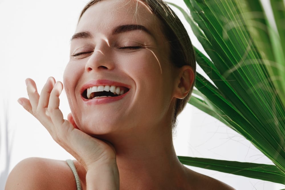 Smiling woman with glowing skin – Kirkland Laser Treatment Close-up of a happy woman with glowing skin and natural light, representing smooth results after - Kirkland Laser Treatment